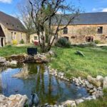 Pond, stones, buildings, Zanni Compagnie